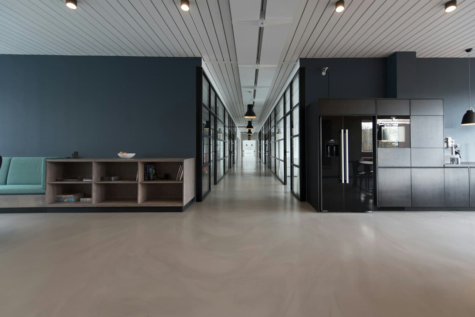 Bright office corridor with glass meeting rooms